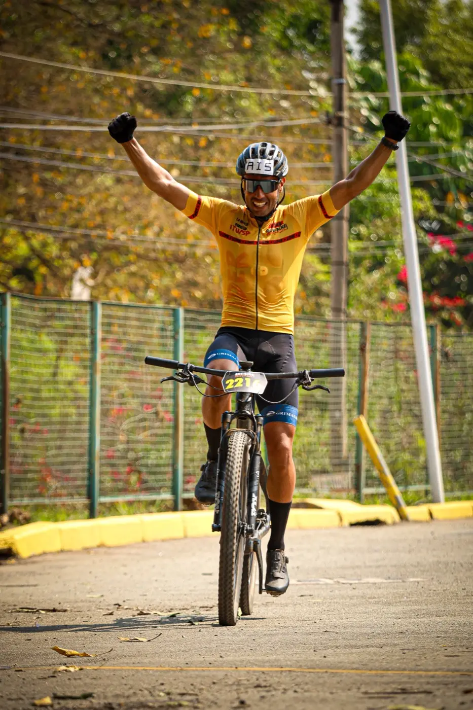 Atleta comemorando de braços erguidos na chegada